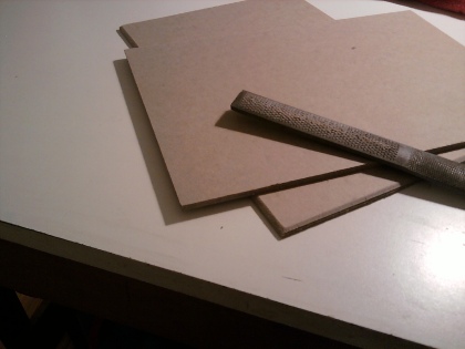 Prepping the high-density bookboard - using a wood rasp to bevel the edges, which was typical for books of this era.